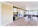 Enclosed patio featuring neutral colors, table and chairs, ceiling fan, and storage shelves at 7205 San Luis Ct, Tampa, FL 33634