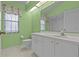 Bathroom with a single sink, tile floors, and a large mirror at 731 Waterside Ct, Tarpon Springs, FL 34689