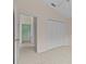 A bright bedroom featuring a closet and a doorway leading to another room at 731 Waterside Ct, Tarpon Springs, FL 34689