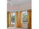 Bright bedroom featuring sliding glass doors to the pool and decorative curtains at 731 Waterside Ct, Tarpon Springs, FL 34689