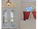 Elegant foyer featuring decorative glass doors and a transom window, creating a bright and welcoming entry at 731 Waterside Ct, Tarpon Springs, FL 34689