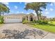 Beautifully landscaped front yard with a circular driveway leading to a charming single-story home at 731 Waterside Ct, Tarpon Springs, FL 34689