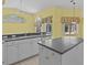 Bright kitchen features an island, white cabinets, and granite countertops at 731 Waterside Ct, Tarpon Springs, FL 34689