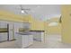 Bright kitchen with white cabinets, an island, and a view of the adjacent dining area at 731 Waterside Ct, Tarpon Springs, FL 34689
