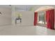 Open-concept living room with tiled floors and access to a screened lanai and pool area at 731 Waterside Ct, Tarpon Springs, FL 34689