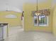 Open living space with tiled floors, large windows, and view of the pool at 731 Waterside Ct, Tarpon Springs, FL 34689