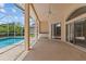 A covered patio with a pool and outdoor furniture makes a great entertaining area at 731 Waterside Ct, Tarpon Springs, FL 34689