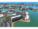 Ariel view showing a waterfront condo in a community with marina access, tennis courts, and a swimming pool at 7910 Sun Island S Dr # 203, South Pasadena, FL 33707