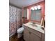 Bathroom featuring a vanity with storage, a decorative shower curtain, and neutral color scheme at 7910 Sun Island S Dr # 203, South Pasadena, FL 33707