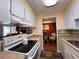 Well-equipped kitchen featuring white cabinets and modern appliances, seamlessly connecting to the dining area at 7910 Sun Island S Dr # 203, South Pasadena, FL 33707