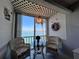 Charming sunroom with water view, lattice ceiling, and wicker chairs at 7910 Sun Island S Dr # 203, South Pasadena, FL 33707