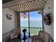 Inviting sunroom with scenic water view, decorative wreath, and unique lattice ceiling at 7910 Sun Island S Dr # 203, South Pasadena, FL 33707