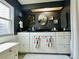 Dark bathroom with a sink and white cabinets at 808 53Rd E Ave # 142K, Bradenton, FL 34203