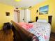 Cozy bedroom with floral bedding and yellow walls at 808 53Rd E Ave # 142K, Bradenton, FL 34203
