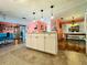 Spacious kitchen featuring a central island, tile flooring, and seamlessly flows into the dining area at 808 53Rd E Ave # 142K, Bradenton, FL 34203