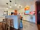 Stylish kitchen with white cabinets, a center island with seating, and modern lighting fixtures at 808 53Rd E Ave # 142K, Bradenton, FL 34203