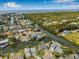Aerial view of a home on the water with a pool in a neighborhood with boat docks at 8727 Bay Crest Ln, Tampa, FL 33615