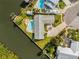 Aerial view of a waterfront home with two swimming pools and boat dock at 8727 Bay Crest Ln, Tampa, FL 33615