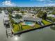Aerial view of a waterfront home with a pool and lush green lawn at 8727 Bay Crest Ln, Tampa, FL 33615