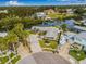Aerial view of waterfront property featuring a boat, ample parking, and meticulously kept landscaping at 8727 Bay Crest Ln, Tampa, FL 33615