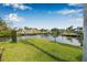 A well-manicured lawn leads to a waterfront view with a dock, perfect for enjoying waterfront activities at 8727 Bay Crest Ln, Tampa, FL 33615