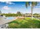An inviting backyard with a pool, deck, and lush lawn leading to a waterfront view at 8727 Bay Crest Ln, Tampa, FL 33615