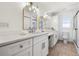Stylish bathroom featuring double sinks, modern lighting, and ample cabinet space at 8727 Bay Crest Ln, Tampa, FL 33615