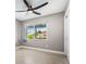Cozy bedroom with neutral paint, ceiling fan and window overlooking the outdoor view at 8727 Bay Crest Ln, Tampa, FL 33615