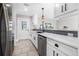 Kitchen view featuring white cabinets, stainless steel appliances, and a backyard door at 8727 Bay Crest Ln, Tampa, FL 33615
