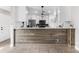 Kitchen featuring a wraparound breakfast bar with white cabinetry and wooden accent wall at 8727 Bay Crest Ln, Tampa, FL 33615