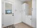 Clean laundry room featuring white cabinets, a door to the outside, and tile floor at 8727 Bay Crest Ln, Tampa, FL 33615