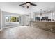 Bright living room showcasing tile floors, a ceiling fan, and a view of the outdoors at 8727 Bay Crest Ln, Tampa, FL 33615