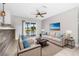 Living room with neutral decor, large sofa, chairs, and sliding glass doors to the lanai at 8727 Bay Crest Ln, Tampa, FL 33615