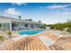 Beautiful backyard with sparkling pool, canal views, and sun loungers for outdoor relaxation at 8727 Bay Crest Ln, Tampa, FL 33615