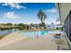 Pool and canal view with a patio, table and chairs for outdoor entertaining at 8727 Bay Crest Ln, Tampa, FL 33615