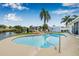 Backyard view of a pool, wooden dock, and waterway behind the house at 8727 Bay Crest Ln, Tampa, FL 33615