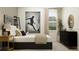 Stylish bedroom featuring a modern bed, decorative artwork, and ample natural light, creating a comfortable and inviting space at 9590 Runaway Breeze Dr, Land O Lakes, FL 34637