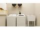 Clean laundry room featuring modern washer and dryer with utility sink and overhead shelving at 9590 Runaway Breeze Dr, Land O Lakes, FL 34637