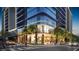 Modern building entrance with glass windows, beautiful landscaping, and well dressed pedestrians at street level at 1101 E Jackson St # 2008, Tampa, FL 33602