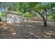 Large backyard, featuring mature trees and partial view of screened in back porch at 1105 Oakview Ave, Clearwater, FL 33756