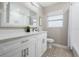 Bathroom featuring a white vanity with countertop, decorative floor tiles, and contemporary fixtures at 1105 Oakview Ave, Clearwater, FL 33756