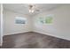 Sunlit bedroom featuring wood-look flooring, fresh white walls, two windows, and a modern ceiling fan at 1105 Oakview Ave, Clearwater, FL 33756