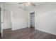 Neutral bedroom featuring wood-look flooring, a ceiling fan, and a walk-in closet with built-in shelving at 1105 Oakview Ave, Clearwater, FL 33756