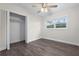 Sunlit bedroom featuring wood-look flooring, fresh white walls, a window, and a walk-in closet at 1105 Oakview Ave, Clearwater, FL 33756