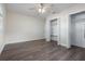 Neutral bedroom featuring wood-look flooring, a ceiling fan, and a walk-in closet with built-in shelving at 1105 Oakview Ave, Clearwater, FL 33756