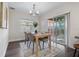 Cozy dining area with a wooden table, natural light from sliding glass doors, and access to the patio at 1105 Oakview Ave, Clearwater, FL 33756