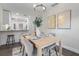 Elegant dining room features a wooden table, modern chandelier, and artwork at 1105 Oakview Ave, Clearwater, FL 33756