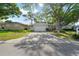 Inviting one-story home featuring a well-manicured lawn, a driveway, and an attached garage at 1105 Oakview Ave, Clearwater, FL 33756
