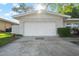 Attached white garage showcasing a clean, modern facade with manicured landscaping at 1105 Oakview Ave, Clearwater, FL 33756
