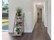 Bright hallway with wood-look flooring, a decorative plant stand, and natural light from the nearby window at 1105 Oakview Ave, Clearwater, FL 33756
